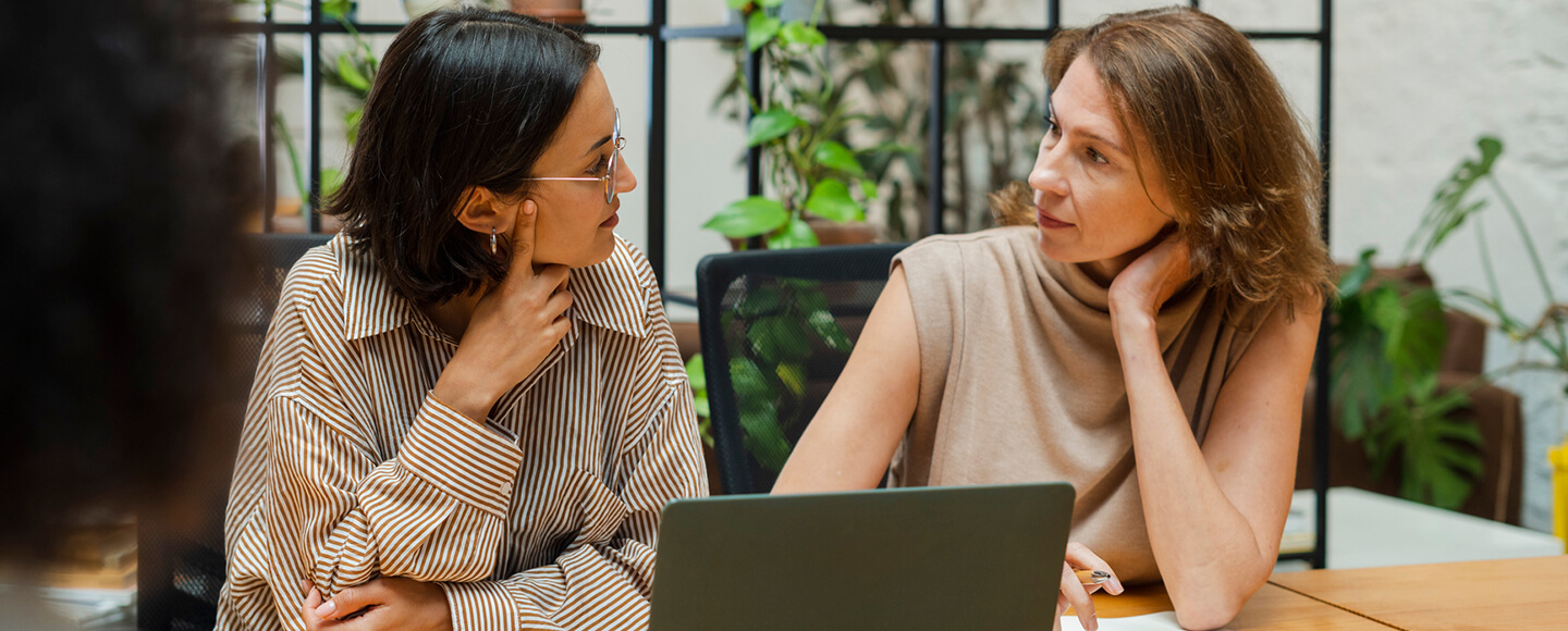 Two women in a coaching conversation, representing C-suite coaching and female leadership coaching