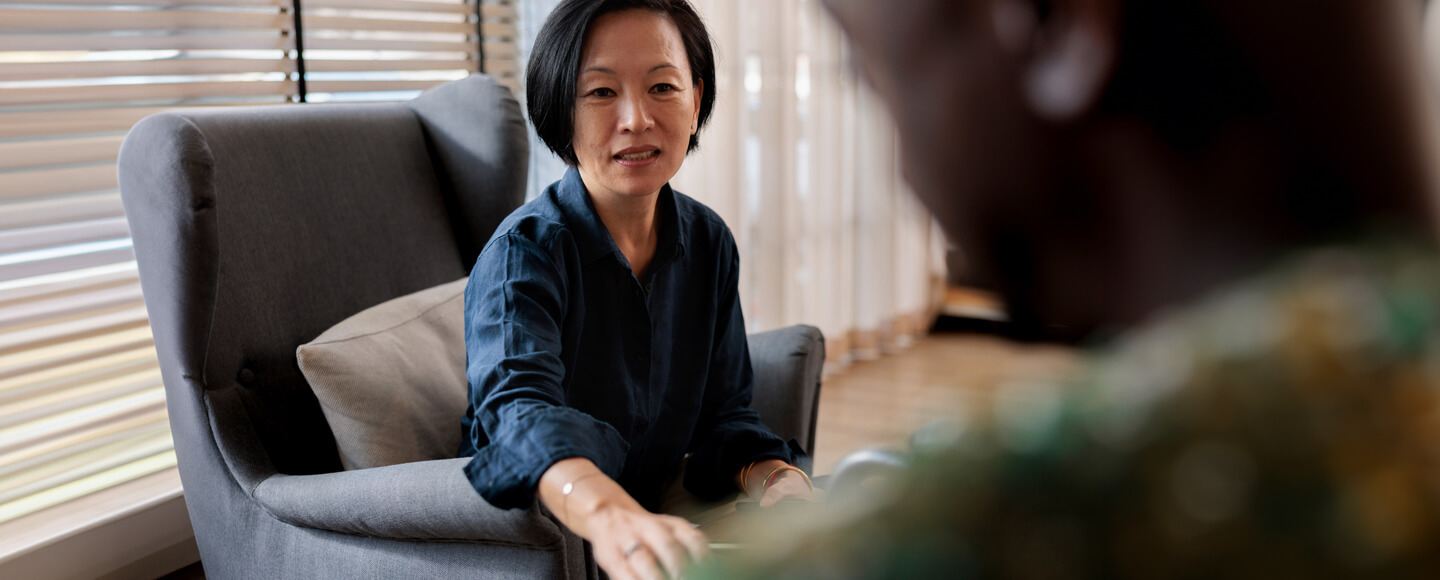 Woman listening attentively during a conversation, representing empathetic leadership and leading with empathy