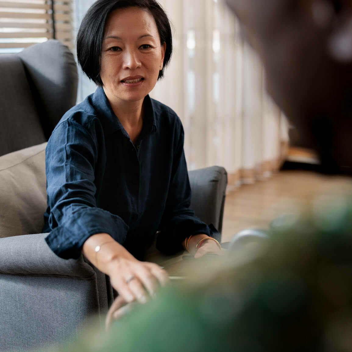 Woman listening attentively during a conversation, representing empathetic leadership and leading with empathy