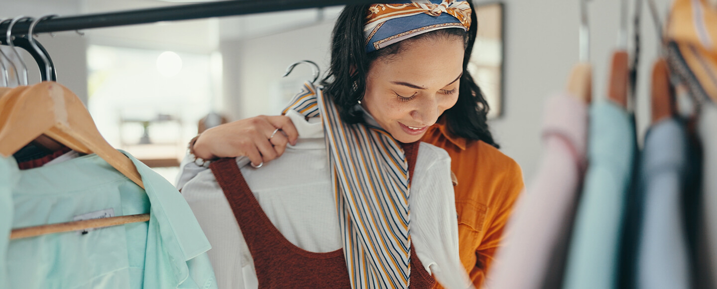 Woman in midlife choosing an outfit from her wardrobe, exploring personal style and midlife fashion