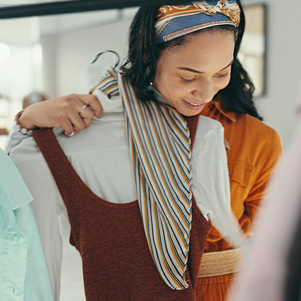 Woman in midlife choosing an outfit from her wardrobe, exploring personal style and midlife fashion