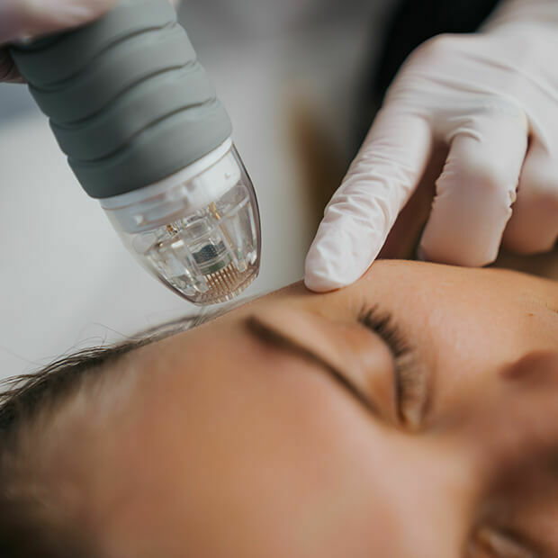 Close-up of a woman receiving a facial tweakment, supporting a guide on how to age well as a woman